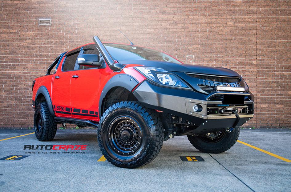 Modified Mazda BT-50 with KMC XD Panzer wheels and Toyo tyres front close-up view