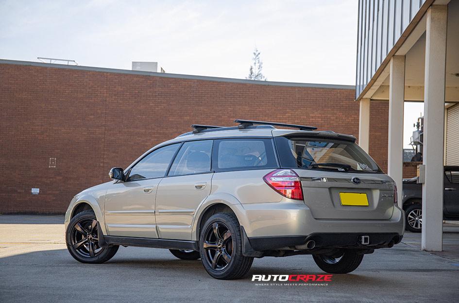 SUBARU OUTBACK BADGER GLOSS BLACK DARK TINT FACE